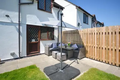 a patio with a table and an umbrella at 4 Bed in Padstow oc-p00759 in Padstow