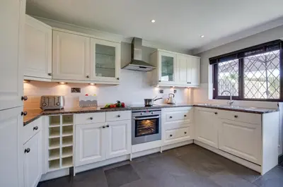 a kitchen with white cabinets and a stove at 4 Bed in Padstow oc-p00759 in Padstow