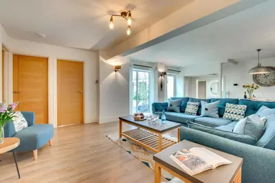 a living room with a blue couch and a table at 3 Bed in Padstow oc-p00793 in Padstow