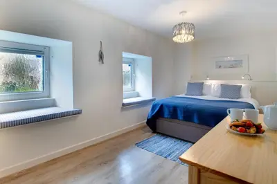 a bedroom with a bed and a bowl of fruit on a table at 3 Bed in Padstow oc-p00793 in Padstow