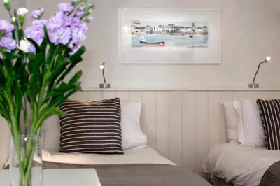 a vase of purple flowers sitting on a table at 3 Bed in Padstow oc-p00793 in Padstow