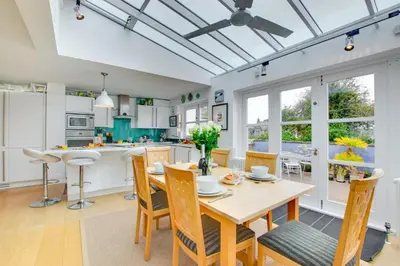 a dining room with a table and chairs and a kitchen at 3 Bed in Padstow oc-p00797 in Padstow
