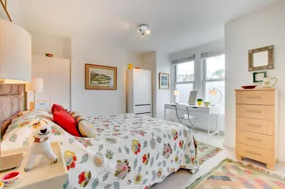 a bedroom with a bed and a desk and a refrigerator at 3 Bed in Padstow oc-p00797 in Padstow