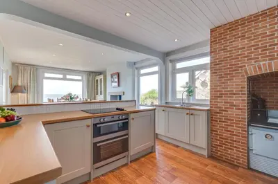 a kitchen with a brick wall and a stove top oven at 3 Bed in Praa Sands oc-p00859 in Praa Sands