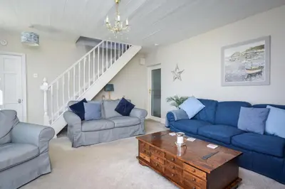 a living room with blue couches and a coffee table at 3 Bed in Praa Sands oc-p00859 in Praa Sands
