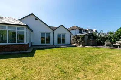 a house with a lawn in front of it at 4 Bed in Trevone oc-p00863 in Padstow