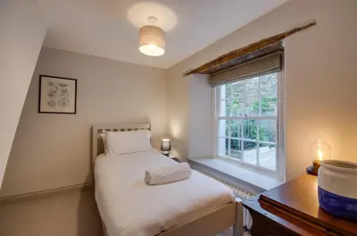 a bedroom with a bed and a window at 3 Bed in Fowey oc-p00871 in Fowey