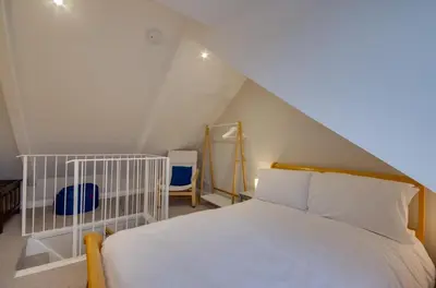 a bedroom with a white bed in a attic at 3 Bed in Fowey oc-p00871 in Fowey