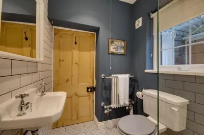 a bathroom with a sink and a toilet and a mirror at 3 Bed in Fowey oc-p00871 in Fowey