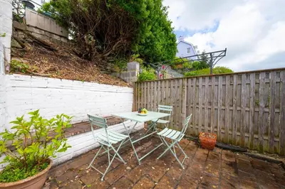 a table and chairs on a patio with a fence at 3 Bed in Fowey oc-p00871 in Fowey