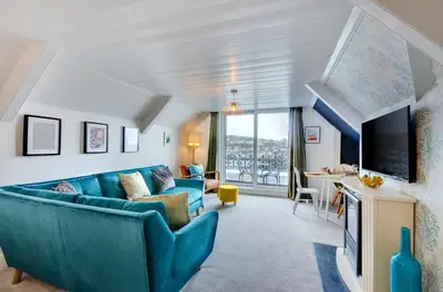 a living room with a blue couch and a tv at 2 Bed in Fowey oc-p00873 in Fowey