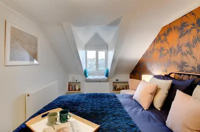 a bedroom with a blue bed and a table at 2 Bed in Fowey oc-p00873 in Fowey