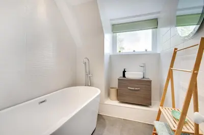 a white bathroom with a tub and a sink at 2 Bed in Fowey oc-p00873 in Fowey