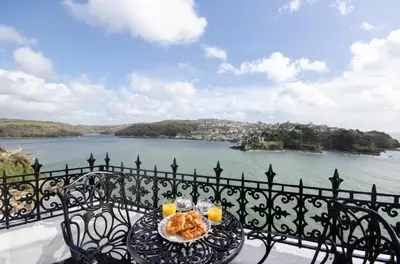 a table with a plate of food on top of a balcony at 2 Bed in Fowey oc-p00873 in Fowey