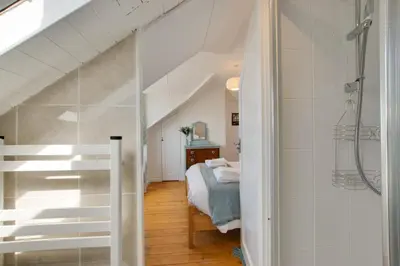 a bathroom with a shower and a bed in a room at 3 Bed in Porthleven oc-p00877 in Porthleven