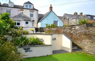 a garden with a retaining wall and a house at 3 Bed in Padstow oc-p00807 in Padstow