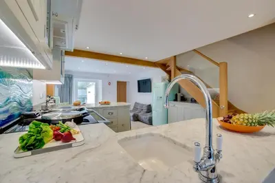 a kitchen with a sink and a plate of food on a counter at 3 Bed in Padstow oc-p00807 in Padstow