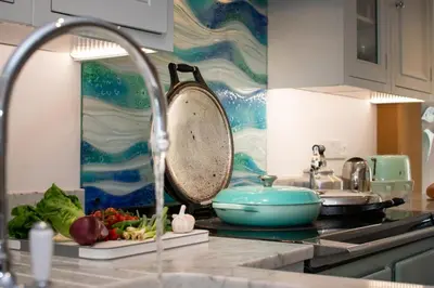 a kitchen counter with a sink with a pan and vegetables at 3 Bed in Padstow oc-p00807 in Padstow