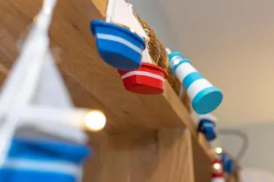 a close up of a toothbrush hanging from a table at 3 Bed in Padstow oc-p00807 in Padstow
