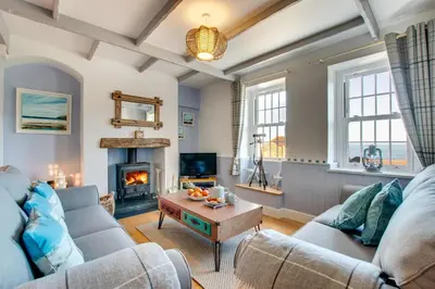 a living room with a couch and a fireplace at 3 Bed in Gorran Haven oc-p00812 in Gorran Haven