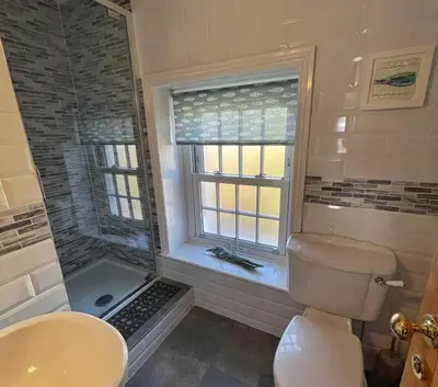a bathroom with a toilet and a sink and a window at 3 Bed in Gorran Haven oc-p00812 in Gorran Haven