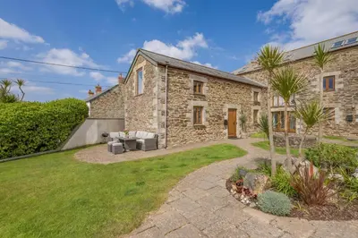 an exterior view of a stone house with a yard at 3 Bed in Mawgan Porth oc-p00824 in Mawgan Porth