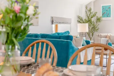 a living room with a couch and a table with chairs at 3 Bed in Mawgan Porth oc-p00824 in Mawgan Porth