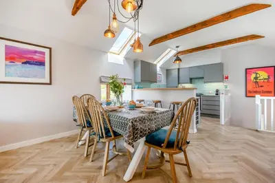 a kitchen and dining room with a table and chairs at 3 Bed in Mawgan Porth oc-p00824 in Mawgan Porth