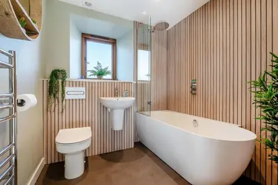 a bathroom with a tub and a toilet and a sink at 3 Bed in Mawgan Porth oc-p00824 in Mawgan Porth
