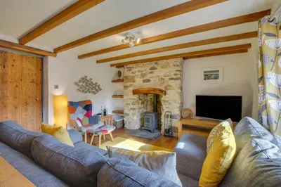 a living room with a couch and a fireplace at 2 Bed in Talskiddy oc-p00844 in Saint Columb Major