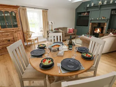 a dining room with a table with plates and food on it at Gilly Skyber in Helston