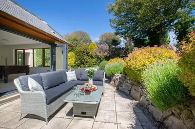 a patio with a couch and a table at 7 Bed in Ashton oc-p00891 in Germoe
