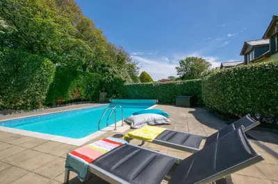 a swimming pool with two lounge chairs next to a swimming pool at 7 Bed in Ashton oc-p00891 in Germoe