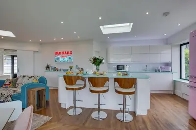a kitchen and living room with a bar with stools at 5 Bed in Newquay oc-p00894 in Newquay