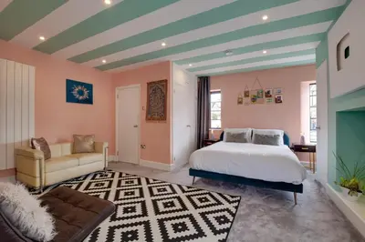 a bedroom with a bed and a couch at 5 Bed in Newquay oc-p00894 in Newquay