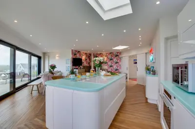 a kitchen with a large island with blue counter tops at 5 Bed in Newquay oc-p00894 in Newquay