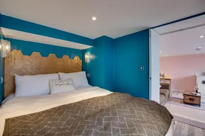 a bedroom with a large bed with blue walls at 5 Bed in Newquay oc-p00894 in Newquay