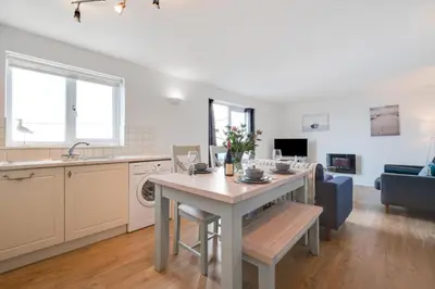 a kitchen and living room with a table and a couch at 2 Bed in Porthleven oc-p00972 in Porthleven