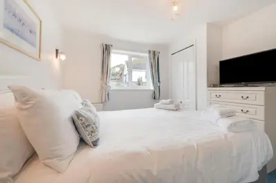 a bedroom with a white bed with towels on it at 2 Bed in Porthleven oc-p00972 in Porthleven