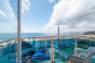 a balcony with chairs and a view of the ocean at 2 Bed in Porthleven oc-p00972 in Porthleven