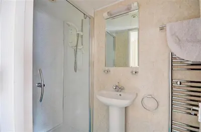 a bathroom with a sink and a shower with a mirror at 1 Bed in St. Ives oc-pc1010 in St Ives