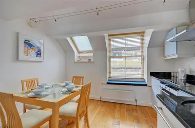 a kitchen and dining room with a table and chairs at 1 Bed in St. Ives oc-pc1010 in St Ives