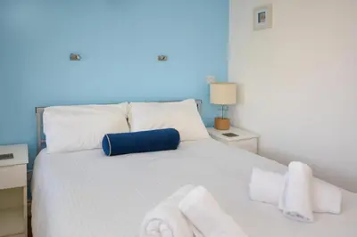 a bedroom with a white bed with towels on it at 1 Bed in St. Ives oc-pc1010 in St Ives
