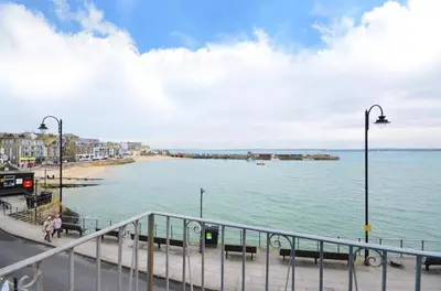 a view of a beach with a pier in the water at 1 Bed in St. Ives oc-pc716a in St Ives