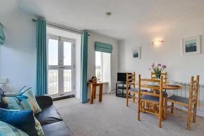 a living room with a table and chairs and a couch at 1 Bed in St. Ives oc-pc716a in St Ives