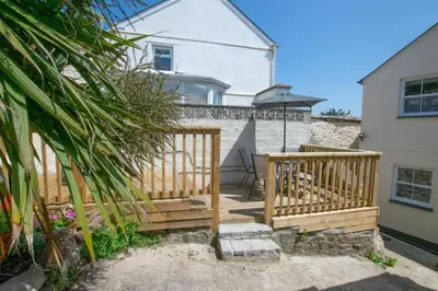 a wooden deck in front of a house at 2 Bed in Porthleven oc-pevcot in Porthleven