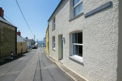 an empty street next to a white building at 2 Bed in Porthleven oc-pevcot in Porthleven