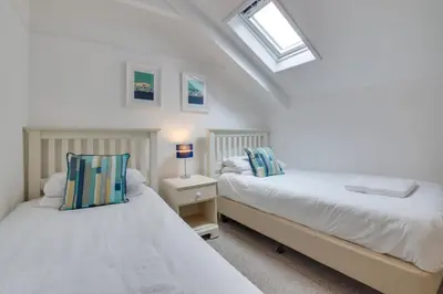 two beds in a white room with a window at 2 Bed in St Ives oc-pc055a in St Ives