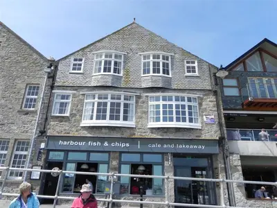an old building with people walking in front of it at 2 Bed in St Ives oc-pc055a in St Ives