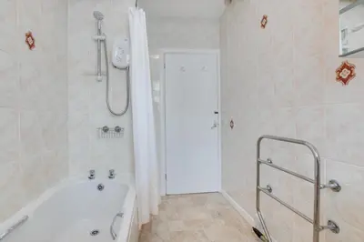 a white bathroom with a tub and a shower at 2 Bed in St Ives oc-pc055a in St Ives